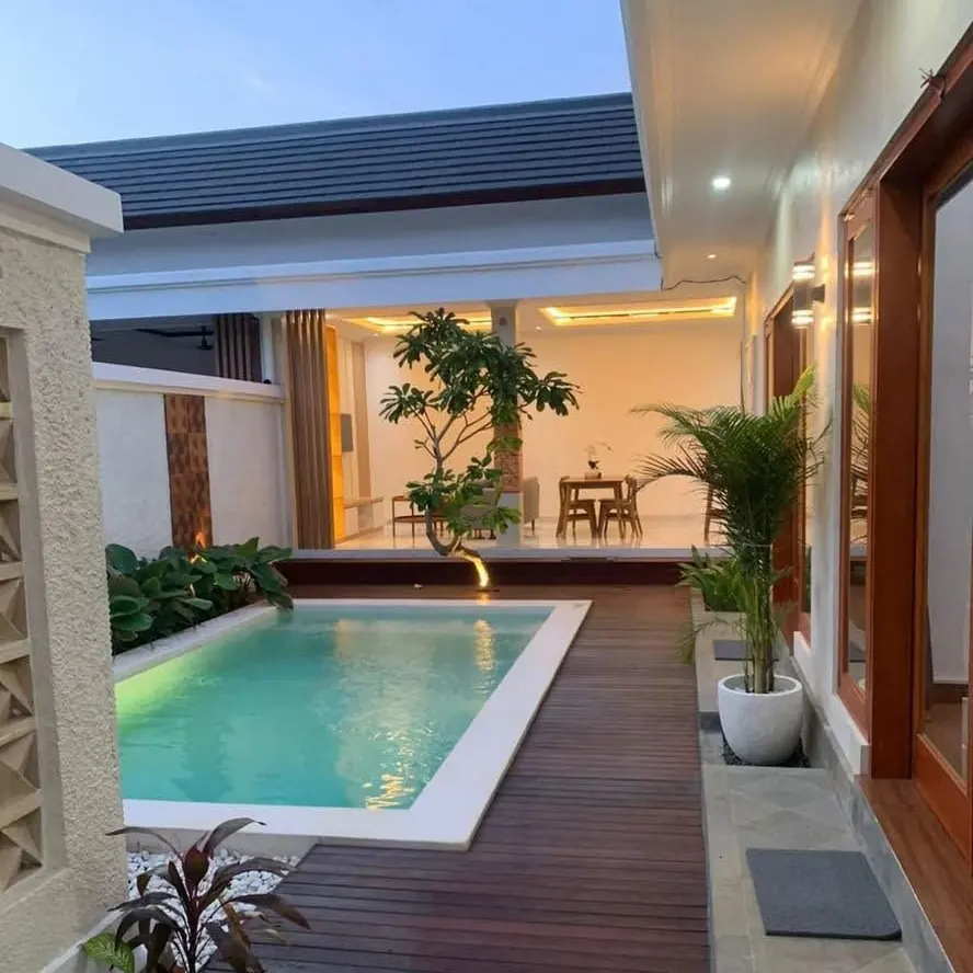 Courtyard pool next to a timber deck and an open living area